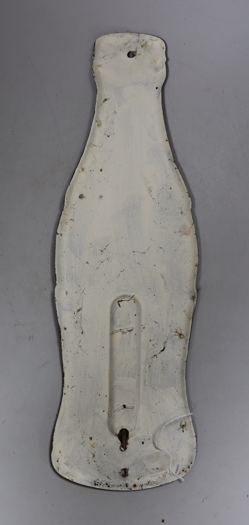 An enamelled Coca-Cola sign in the shape of a bottle, with a thermometer, 43cms high